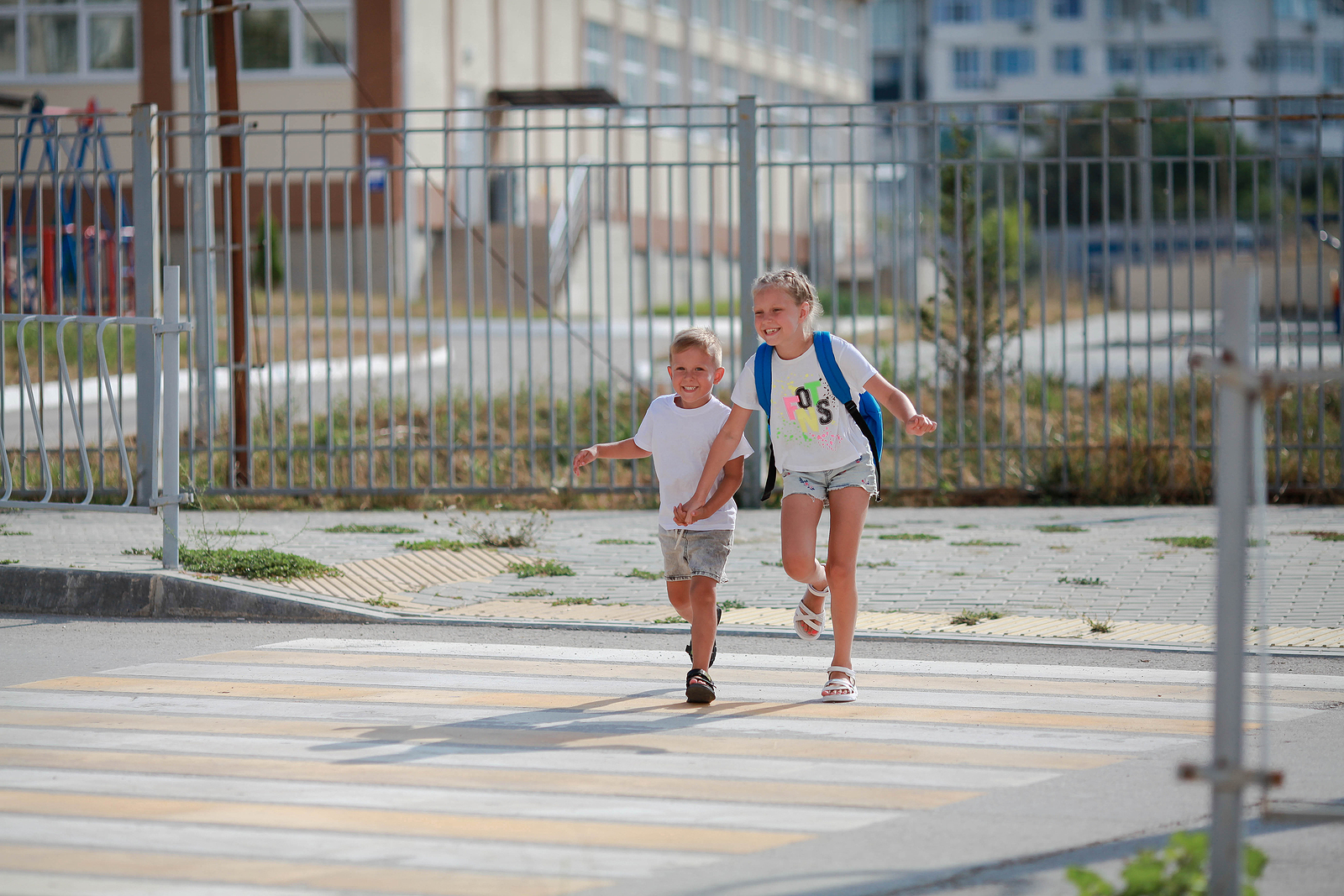 two children run across a road
