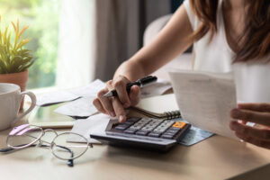 Stressed young woman checking bills